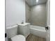 Bright bathroom featuring a shower-tub combo with modern gray tiling and a white vanity at 22011 Catherine Ave, Port Charlotte, FL 33952