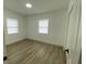 Bright bedroom featuring two windows and vinyl floors at 22011 Catherine Ave, Port Charlotte, FL 33952