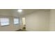 Bright bedroom features two windows for ample natural light and vinyl floors at 22011 Catherine Ave, Port Charlotte, FL 33952