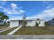 Single-story home with a screened entry, garage, and long driveway at 22011 Catherine Ave, Port Charlotte, FL 33952
