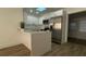 Modern kitchen with white cabinetry, stainless steel appliances, and breakfast bar at 22011 Catherine Ave, Port Charlotte, FL 33952