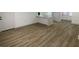 Spacious living room with light wood flooring, leading to a kitchen area at 22011 Catherine Ave, Port Charlotte, FL 33952