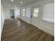 Bright living room featuring wood-look flooring, white walls, recessed lighting, and an exterior door at 22011 Catherine Ave, Port Charlotte, FL 33952