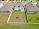 The backyard is large and fenced, with a single young tree planted in the middle of the yard at 5289 Fiddle Fig Ave, Wimauma, FL 33598
