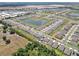 An aerial view of a Primary-planned community featuring water features, manicured lawns, and a grid of residential streets at 5289 Fiddle Fig Ave, Wimauma, FL 33598