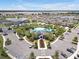 An expansive community featuring a modern clubhouse, a resort-style pool, lush landscaping, and ample parking at 5289 Fiddle Fig Ave, Wimauma, FL 33598