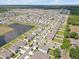 A well-planned community with neatly arranged homes, green spaces, and scenic ponds and landscaping at 5289 Fiddle Fig Ave, Wimauma, FL 33598