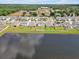Aerial view of houses bordering a reflective pond at 5289 Fiddle Fig Ave, Wimauma, FL 33598