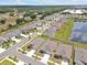 Aerial view of home in quiet neighborhood by pond, showing layout and proximity to amenities at 5289 Fiddle Fig Ave, Wimauma, FL 33598