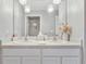 Bright bathroom featuring double vanity, modern lighting, and a neutral color scheme at 5289 Fiddle Fig Ave, Wimauma, FL 33598