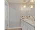 Modern bathroom with double vanity, stylish lighting, and neutral tones, creating a spa-like atmosphere at 5289 Fiddle Fig Ave, Wimauma, FL 33598