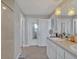 Bathroom featuring vanity with sink and drawers, large mirror, and walk-in shower with neutral tile at 5289 Fiddle Fig Ave, Wimauma, FL 33598