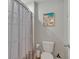 Cozy bathroom featuring a toilet and a shower with decorative curtain at 5289 Fiddle Fig Ave, Wimauma, FL 33598