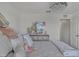 Bright bedroom featuring white walls, chandelier, cozy bed, and a large window at 5289 Fiddle Fig Ave, Wimauma, FL 33598