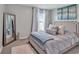 Serene bedroom with a plush bed, soft blue accents, decorative pillows, and a full-length mirror at 5289 Fiddle Fig Ave, Wimauma, FL 33598