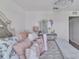 Charming ' bedroom featuring decorative pillows, dresser, and lots of natural light at 5289 Fiddle Fig Ave, Wimauma, FL 33598