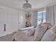 Bright ' bedroom featuring a decorative light fixture, comfortable bed, and playful accents at 5289 Fiddle Fig Ave, Wimauma, FL 33598