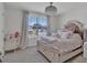 Bright bedroom featuring a cozy bed, ample natural light, and elegant decor at 5289 Fiddle Fig Ave, Wimauma, FL 33598