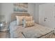Cozy bedroom features soft lighting, a plush bed, and stylish decorations at 5289 Fiddle Fig Ave, Wimauma, FL 33598