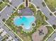 Overhead view of community pool and playground, showing the layout, landscaping, and parking area at 5289 Fiddle Fig Ave, Wimauma, FL 33598