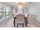 Formal dining room with a contemporary chandelier, decorative mirrors, and neutral decor for elegant gatherings at 5289 Fiddle Fig Ave, Wimauma, FL 33598