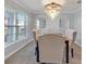 Bright dining room featuring an elegant chandelier and upholstered chairs at 5289 Fiddle Fig Ave, Wimauma, FL 33598