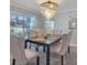 Elegant dining room with a dark wood table and neutral upholstered chairs at 5289 Fiddle Fig Ave, Wimauma, FL 33598