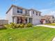 Beautiful two-story home with well-kept lawn, colorful landscaping, and a convenient two-car garage at 5289 Fiddle Fig Ave, Wimauma, FL 33598