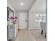 Inviting foyer featuring tile flooring, a stylish mirror, and a glimpse into the adjacent dining area at 5289 Fiddle Fig Ave, Wimauma, FL 33598