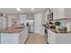 Open concept kitchen featuring stainless steel appliances and stone countertops at 5289 Fiddle Fig Ave, Wimauma, FL 33598