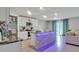 Modern kitchen featuring an island with stylish lighting and stainless steel appliances at 5289 Fiddle Fig Ave, Wimauma, FL 33598
