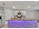 Bright kitchen island features stone accents, a marble countertop, and overhead lighting at 5289 Fiddle Fig Ave, Wimauma, FL 33598