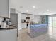 Spacious kitchen featuring a center island, modern appliances, granite countertops, and ample storage space at 5289 Fiddle Fig Ave, Wimauma, FL 33598
