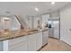 Bright kitchen with an island featuring a stone countertop and stainless steel appliances at 5289 Fiddle Fig Ave, Wimauma, FL 33598