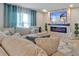 Comfortable living room with plush seating and a unique fireplace feature at 5289 Fiddle Fig Ave, Wimauma, FL 33598