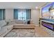 Living room with a large sectional sofa and a modern fireplace feature at 5289 Fiddle Fig Ave, Wimauma, FL 33598