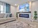 Spacious living room with modern fireplace and large sectional sofa at 5289 Fiddle Fig Ave, Wimauma, FL 33598