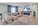Cozy living room featuring a plush sectional sofa and a modern fireplace with blue accent lighting at 5289 Fiddle Fig Ave, Wimauma, FL 33598
