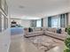 Open-concept living room and kitchen with Christmas tree decoration at 5289 Fiddle Fig Ave, Wimauma, FL 33598