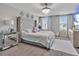 A stunning main bedroom has a crystal chandelier and huge headboard at 5289 Fiddle Fig Ave, Wimauma, FL 33598