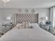 The main bedroom with tufted headboard and mirrored nightstands at 5289 Fiddle Fig Ave, Wimauma, FL 33598