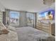 Bright main bedroom featuring plush bedding, lots of natural light, and sleek dresser at 5289 Fiddle Fig Ave, Wimauma, FL 33598