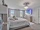 The main bedroom features a TV, crystal chandelier, and luxury touches at 5289 Fiddle Fig Ave, Wimauma, FL 33598