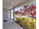Charming front porch with vibrant landscaping, offering a delightful curb appeal at 5289 Fiddle Fig Ave, Wimauma, FL 33598