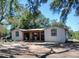 Charming home featuring a covered porch connecting two separate living areas with mature trees offering shade at 6434 Black Dairy Rd, Seffner, FL 33584
