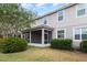 Home exterior with screened in back porch and backyard with grass and landscaping at 12232 Trailhead Dr, Bradenton, FL 34211