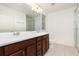 Bathroom with double sinks, white counter tops, wood cabinets, and a glass shower at 12232 Trailhead Dr, Bradenton, FL 34211