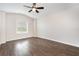 This is a bedroom with hard wood floors, a ceiling fan, and a single window at 12232 Trailhead Dr, Bradenton, FL 34211