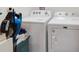 Laundry room with white appliances and good storage at 1324 Ocean Spray Dr, Ruskin, FL 33570