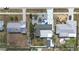 A high-angle aerial view shows the home's unique driveway, landscaping, roof and neighborhood layout at 1790 Pomelo Dr, Venice, FL 34293